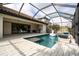 Luxury pool and patio with screened enclosure, outdoor kitchen, and fire pit at 6648 Sunset Vista Way, Land O Lakes, FL 34637