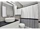 Modern bathroom with floating sink, shower, and black accents at 7503 Wakulla Dr, Temple Terrace, FL 33637