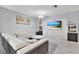 Living room featuring a white sectional sofa and built-in entertainment center at 7503 Wakulla Dr, Temple Terrace, FL 33637