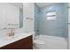 Bathroom with a modern vanity, bathtub, and blue tile at 7810 10Th S Ave, St Petersburg, FL 33707