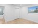 Light-filled bedroom featuring hardwood floors and built-in closet at 7810 10Th S Ave, St Petersburg, FL 33707