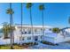 Two-story home with white exterior and palm trees at 7810 10Th S Ave, St Petersburg, FL 33707