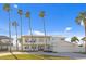 Two-story waterfront home with palm trees and a paved driveway at 7810 10Th S Ave, St Petersburg, FL 33707