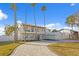 Beautiful two-story home with a paved driveway and palm trees at 7810 10Th S Ave, St Petersburg, FL 33707