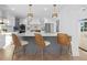 Modern kitchen island with gray cabinets and woven rattan barstools at 7810 10Th S Ave, St Petersburg, FL 33707