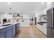 Modern kitchen with white and blue cabinetry, and stainless steel appliances at 7810 10Th S Ave, St Petersburg, FL 33707