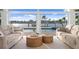 Waterfront living room with two wicker coffee tables at 7810 10Th S Ave, St Petersburg, FL 33707