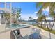 Relaxing pool and spa area with outdoor seating and spiral staircase at 7810 10Th S Ave, St Petersburg, FL 33707