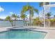 Inviting pool and spa with blue tile and a spiral staircase at 7810 10Th S Ave, St Petersburg, FL 33707