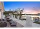 Evening view from waterfront deck with seating area overlooking the water at 7810 10Th S Ave, St Petersburg, FL 33707