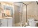 Well-lit bathroom featuring a glass shower, a vanity with storage, and neutral tile flooring at 801 83Rd N Ave # 217, St Petersburg, FL 33702