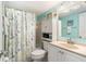 Bright bathroom with a shower-tub combination, white vanity, updated sink, and charming nautical decor at 801 83Rd N Ave # 217, St Petersburg, FL 33702