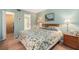 Comfortable bedroom with wood floors, floral bedding, and ensuite bathroom at 801 83Rd N Ave # 217, St Petersburg, FL 33702