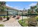 Courtyard with barbecue grills, seating, and palm trees at 801 83Rd N Ave # 217, St Petersburg, FL 33702