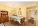 Cozy dining area with wood floors, a quaint chandelier, and connection to the hallway and kitchen at 801 83Rd N Ave # 217, St Petersburg, FL 33702