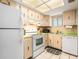 Functional kitchen with white appliances and bright lighting at 801 83Rd N Ave # 217, St Petersburg, FL 33702