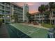 A shuffleboard court with comfortable lounge chairs next to a condo at dusk at 801 83Rd N Ave # 217, St Petersburg, FL 33702