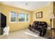 Cozy sitting area with comfortable black leather love seat and large window at 801 83Rd N Ave # 217, St Petersburg, FL 33702