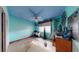 Light blue bedroom with wood dresser and window at 830 S Davis Blvd, Tampa, FL 33606