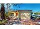 House exterior showcasing a yellow stucco finish and a side yard with stone pathway at 830 S Davis Blvd, Tampa, FL 33606