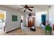 Large living room with a ceiling fan, built-in cabinet, and access to kitchen at 830 S Davis Blvd, Tampa, FL 33606