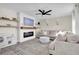 Living room with a modern fireplace, L-shaped sofa, and built-in shelving at 8416 121St Pl, Largo, FL 33773