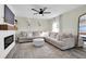 Living room with L-shaped sofa, coffee table, and a fireplace at 8416 121St Pl, Largo, FL 33773