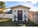 Charming white shed with black door and landscaping at 8416 121St Pl, Largo, FL 33773