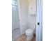 Bathroom featuring a toilet, tiled floor, and white storage cabinets above the commode at 8608 Lake Isle Dr # 0, Temple Terrace, FL 33637