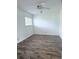 Light-filled bedroom featuring wood-look flooring, a ceiling fan, and a bright, sunny window at 8608 Lake Isle Dr # 0, Temple Terrace, FL 33637