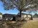 Exterior view of a tan apartment building with a tree in the yard at 8608 Lake Isle Dr # 0, Temple Terrace, FL 33637