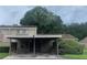 Exterior view of a tan apartment building with a carport at 8608 Lake Isle Dr # 0, Temple Terrace, FL 33637