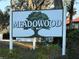 A meadowood sign marks the entrance at 8608 Lake Isle Dr # 0, Temple Terrace, FL 33637