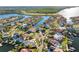 Waterfront neighborhood, aerial view, showcasing multiple homes with private docks and boat access to the river at 952 Symphony Isles Blvd, Apollo Beach, FL 33572