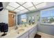 Spacious bathroom featuring double sinks, a vanity with mirrors, natural light from a window and a glass door shower at 952 Symphony Isles Blvd, Apollo Beach, FL 33572