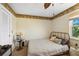 Small bedroom with decorative wallpaper, metal bed frame and side table and lamps for optimal lighting at 952 Symphony Isles Blvd, Apollo Beach, FL 33572