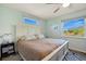 Airy bedroom featuring large windows, a plush rug, and natural light throughout the room at 952 Symphony Isles Blvd, Apollo Beach, FL 33572