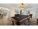 Billiard room features a pool table and view through to the living room and dining area at 952 Symphony Isles Blvd, Apollo Beach, FL 33572