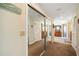 Hallway with closet featuring mirror sliding doors leading to bedrooms and bathrooms at 952 Symphony Isles Blvd, Apollo Beach, FL 33572