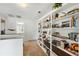 Well-lit hallway featuring built-in bookshelves with decorations and books along with carpeted floors at 952 Symphony Isles Blvd, Apollo Beach, FL 33572