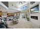 Inviting living room featuring a fireplace, high ceilings, and open layout, perfect for relaxing and entertaining at 952 Symphony Isles Blvd, Apollo Beach, FL 33572