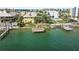 Aerial view of waterfront property with a dock and swimming pool at 9715 Harrell Ave # 25, Treasure Island, FL 33706