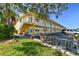 Bright yellow building with multiple units, parking, and bike racks at 9715 Harrell Ave # 25, Treasure Island, FL 33706