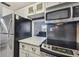 Updated kitchen featuring stainless steel appliances and white cabinets at 9715 Harrell Ave # 25, Treasure Island, FL 33706