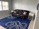 Relaxing living room with leather sofa and blue rug at 9715 Harrell Ave # 25, Treasure Island, FL 33706