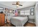 Bedroom with a cozy gray bed, a ceiling fan, and decorated with wall art at 9942 56Th Way, Pinellas Park, FL 33782