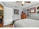 Bedroom with a bed, a ceiling fan, and decorated with wall art and an open doorway at 9942 56Th Way, Pinellas Park, FL 33782