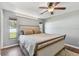 Light bedroom showcases wood floors, two windows, and neutral colored walls at 9942 56Th Way, Pinellas Park, FL 33782