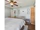 The bedroom boasts dark wood floors and a ceiling fan at 9942 56Th Way, Pinellas Park, FL 33782