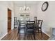 Cozy dining room area adjacent to kitchen with space for six chairs and hardwood flooring at 9942 56Th Way, Pinellas Park, FL 33782